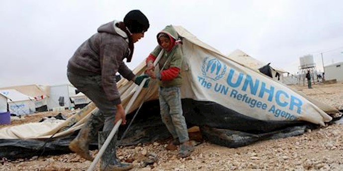  'Syrian refugee children try to put up their tent following a storm at Zaatari Syrian refugee camp in Jordan, Jan. 11, 2015 '