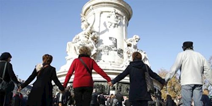  'Parisians paying respect to the victims of the brutal terrorist attacks in Paris by expressing solidarity with the families of those perished'