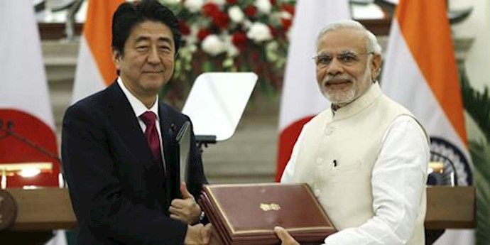  'Japans Prime Minister and his Indian counterpart exchange documents during a signing of agreement in New Delhi, India'