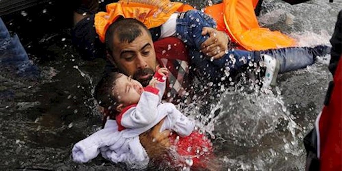  'A Syrian refugee tries to save his children as he struggles to reach the dry land on the Greek island of Lesbos in the Aegean Sea'