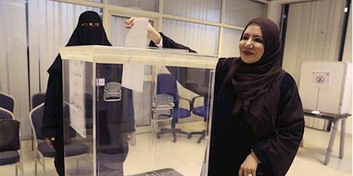  'A Saudi woman casting her vote at a polling station'
