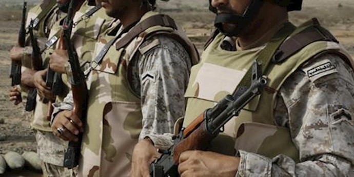  'Saudi soldiers with their weapons stand guard at the Yemen border in Jizan, Saudi Arabia. (AP) '