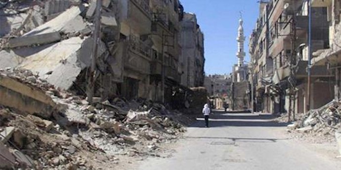  'A man walks on a ruined street in Damascus'