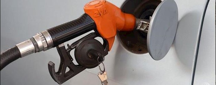  'A motorist filling up petrol at a pump kiosk'