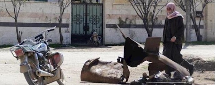  'A man inspects a site targeted by what activists said was a poison gas attack in the village of Sarmin in Idlib province March 17, 2015'