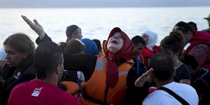  'A woman cries as she arrives aboard a dinghy after crossing from Turkey, to the island of Lesbos, Greece'