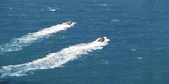  'Two Navy boats speed off in the Persian Gulf on Wednesday after their release by Iranian authorities.'