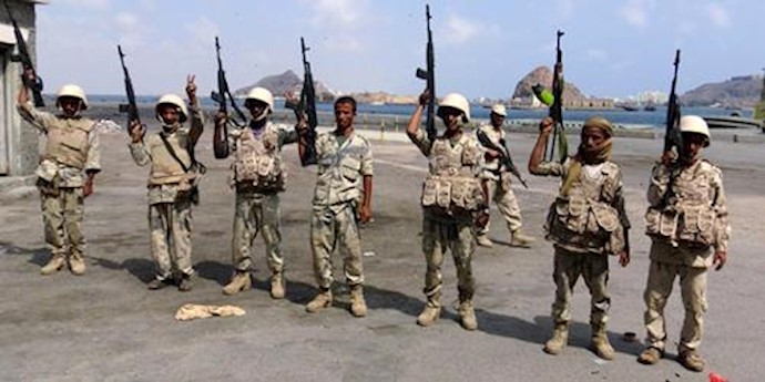  'Army soldiers hold up their weapons after taking over the main port of Yemens southern city of Aden from gunmen'