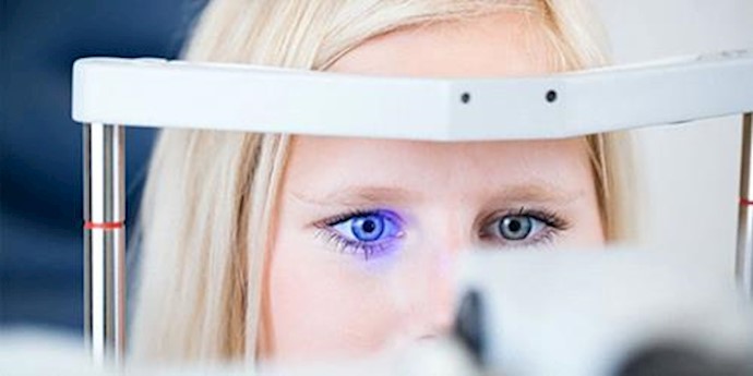  'Woman having laser eye test'