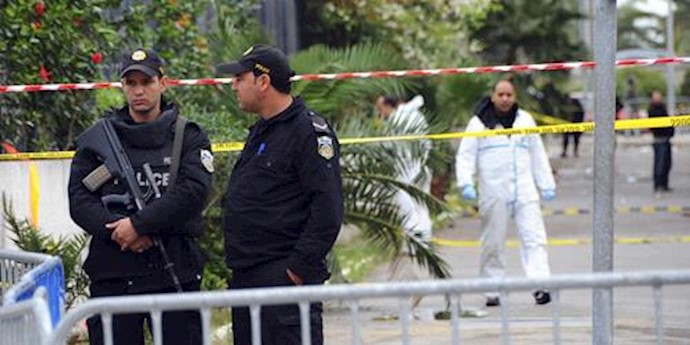  'Police officers secure the area where a bus exploded Tuesday in Tunis'