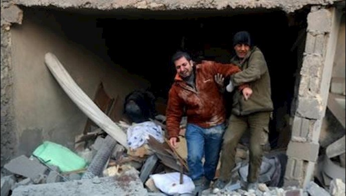  'A man is helped following reported airstrikes on Aleppos rebel-held district of al-Hamra on November 20, 2016'