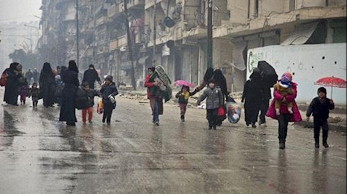  'Syrians leave a rebel-held area of Aleppo towards the government-held side on December 13, 2016'