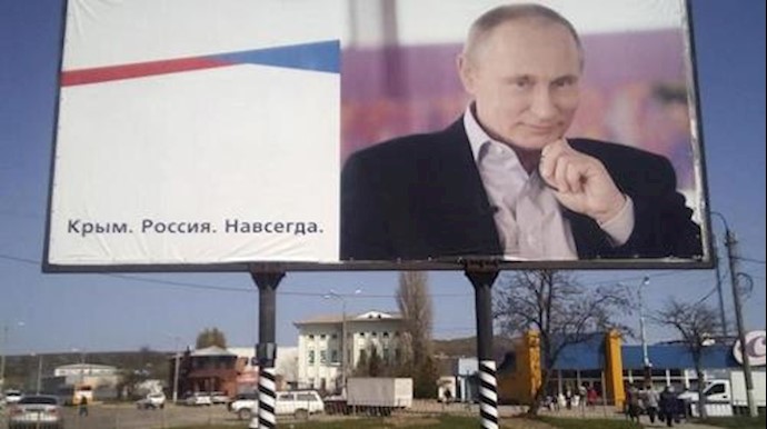  'A billboard with a portrait of Russian President Vladimir Putin is displayed on a street in Kerch, Crimea, April 7, 2016'