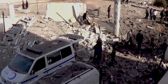  'People gather near what is said to be a hospital damaged by missile attacks in Azaz, Aleppo, Syria'