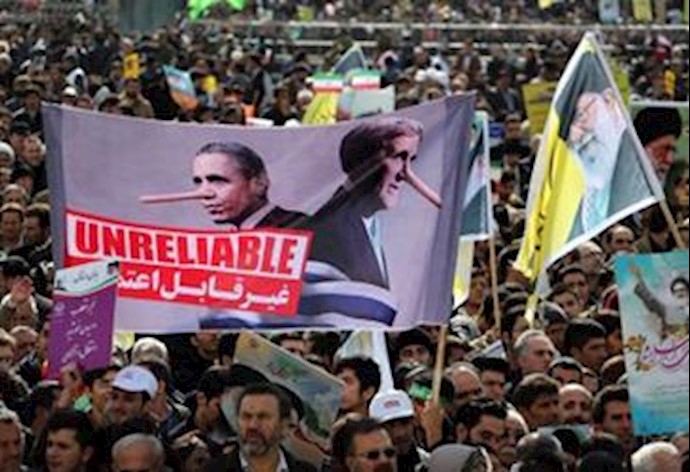 Iranian regime paid elements burns US flag during a regime orchestrated rally in Tehran