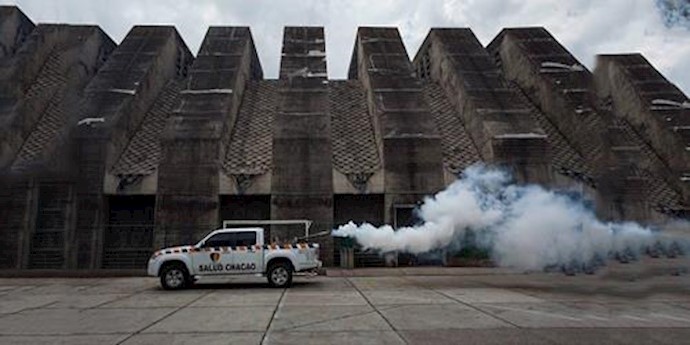  'A municipal employee fumigates outside a church in Caracas, Venezuela, in a bid to prevent the possible spread of the Zika virus in the country'