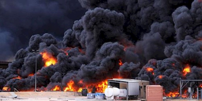  'Smoke rises from burning oil storage tanks in the port of Ras Lanuf, Libya, January 23, 2016'