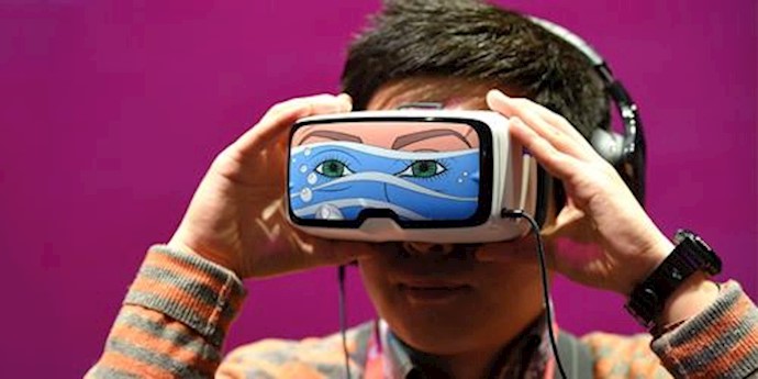  'A boy tests the Oculus VR virtual device, at the Deutsche Telekom stand'