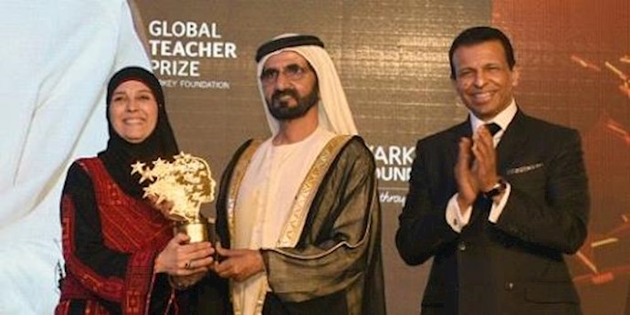  'Hanan Al-Hroub (left) is awarded the Global Teacher award during an award ceremony in Dubai, on March 13, 2016'