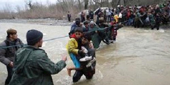 About 2,000 migrants from a camp in northern Greece cross in to Macedonia