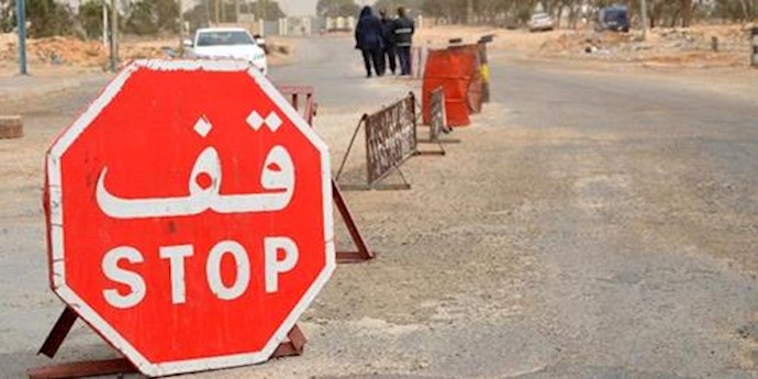  'Tunisian security forces check vehicles near the customs post at the Ras Jedir border crossing with Libya'