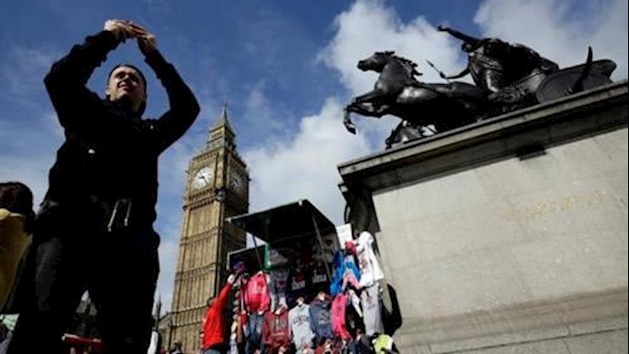  'A man takes a picture near the Big Ben clock tower in London, Britain June 29, 2016'