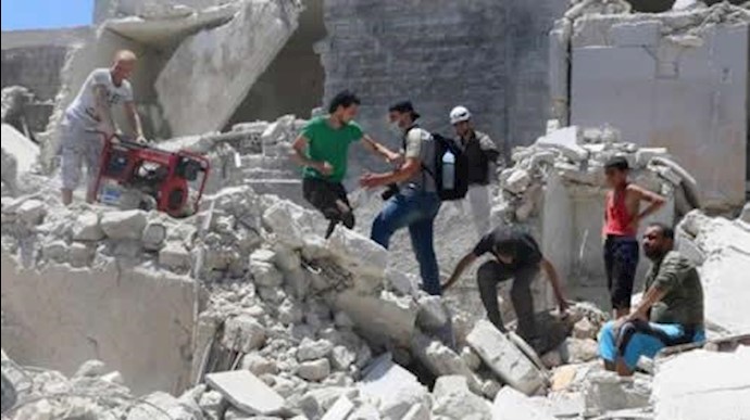  'People walk on the rubble of a site hit by a barrel bomb in the rebel held area of Old Aleppo, Syria July 11, 2016'