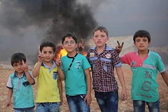 Syrian children create smoke by burning tires to blind Assad Helicopters barrel-bombing their homes