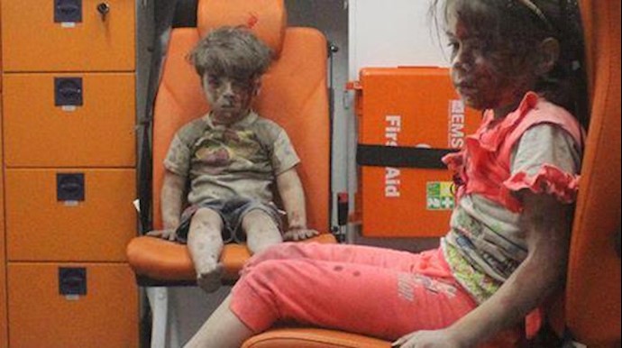  'Omran Dagneesh and this little girl sitting stunned in the ambulance'
