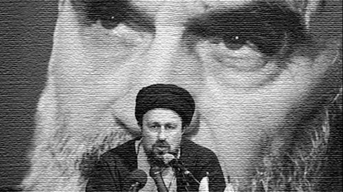  'Hassan Khomeini one of the 15 grandchildren of Khomeini, sits in front of a poster of his grandfather'