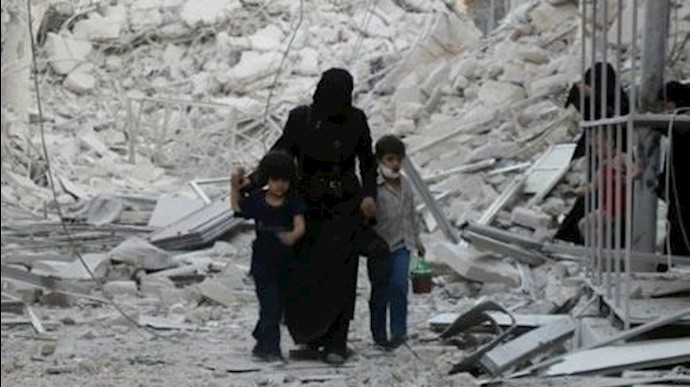  'A Syrian family leaves the area following a reported airstrike on September 23, 2016, on the al-Muasalat area in the northern Syrian city of Aleppo'