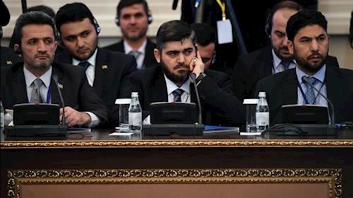  'Chief opposition negotiator Mohammad Alloush (C) of the Jaish al-Islam  rebel group attends the first session of Syria peace talks at Astana'