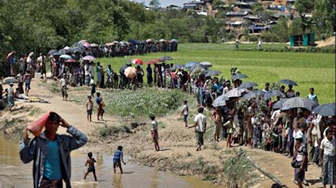  'Rohingya refugees queue for aid in Coxs Bazar, Bangladesh, October 1, 2017'