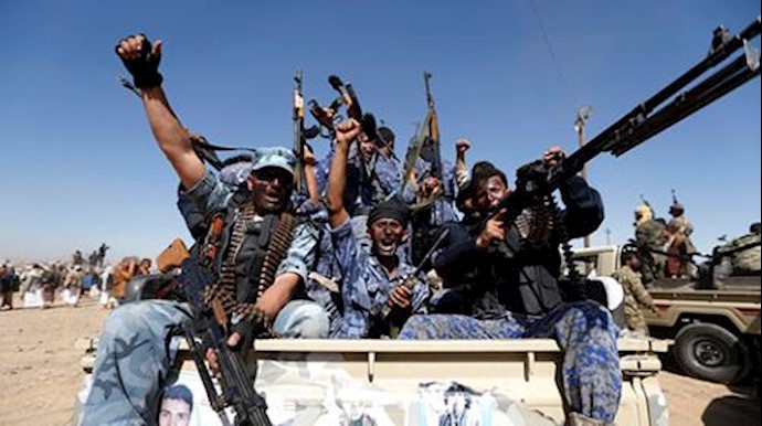  'Newly recruited Houthi fighters chant slogans as they ride a military vehicle, on January 3, 2017'