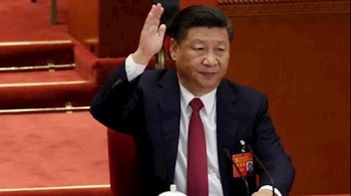  'Chinese President Xi Jinping raises his hand as he takes a vote at the closing session of the 19th National Congress of the Communist Party of China'