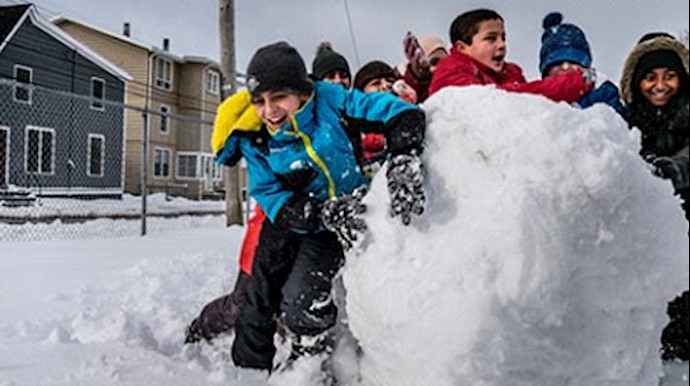  '11-year-old Syrian refugee Basel Alrashdan (light blue jacket) plays with his friends from his school on Prince Edward Island'