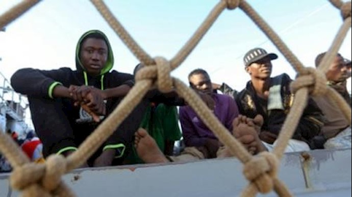  'Migrants and refugees at a naval base in the Libyan capital Tripoli after being rescued off the Libyan coast this month'
