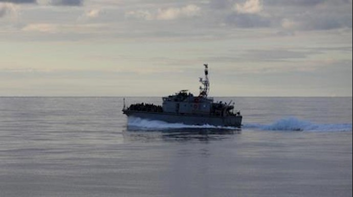  'Migrants are seen on a boat as they are being rescued by Libyan coast guards at the coast of Tripoli in Libya, December 8, 2017'
