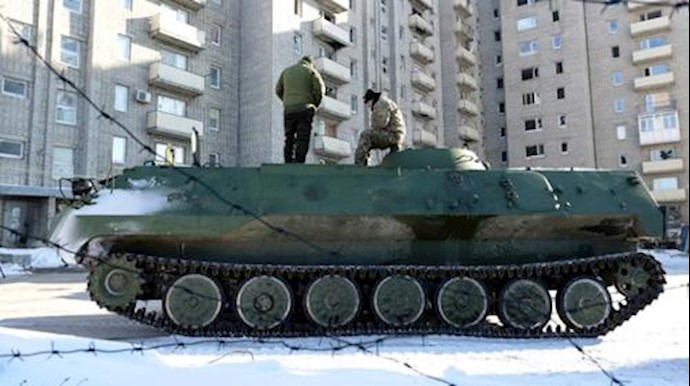  'Ukrainian medical servicemen stand on an Armoured Personnel Carriers in Ukraine-controlled town of Avdiivka on January 30, 2017'