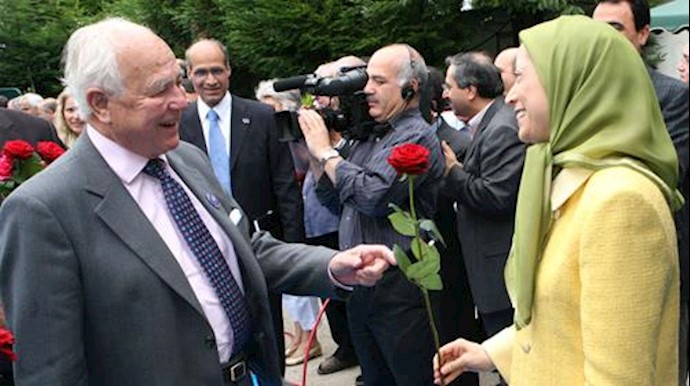  'Maryam Rajavi is giving flower to the Hon. Lord Waddington '
