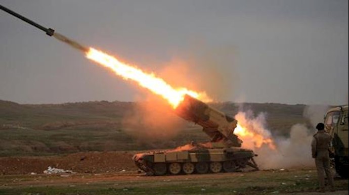  'An Iraqi Army officer uses his mobile phone to film a rocket launched towards Islamic State militants '