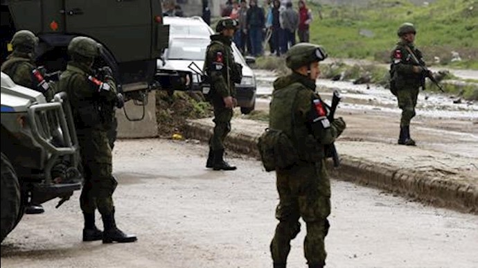  'Russian Military police stand guard to complete the evacuation of fighters and civilians, in the central city of Homs on March 18, 2017'