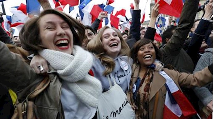  'Macron supporters celebrate in front of The Louvre Museum in Paris on May 7, 2017.'