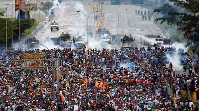 Another youth killed as Venezuela protesters flex muscle in street clashes