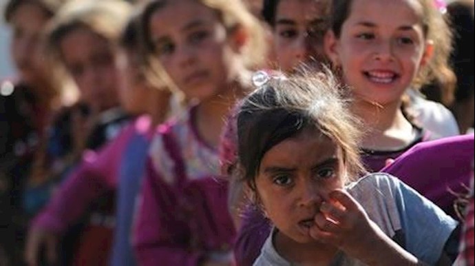  'Children stand in line for food at the Hammam al-Alil camp for internally displaced people south of the battleground Iraqi city of Mosul'