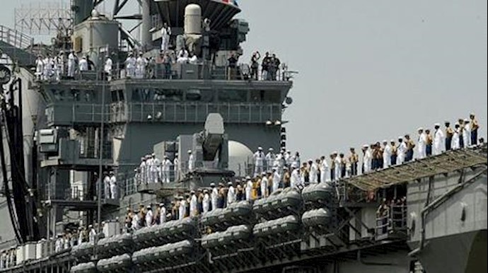  'Sailors and Marines stand on the deck of the USS Bataan (LHD 5) as it arrives into Pier 88 during the Parade of Ships ceremony to kick off Fleet Week '