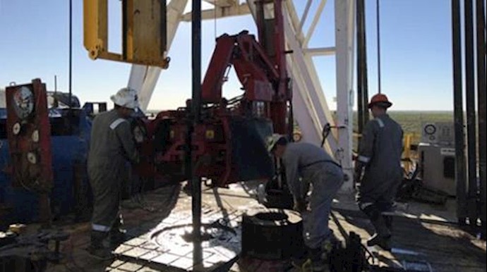 Oil sits near half-year lows as global supply overhang weighs