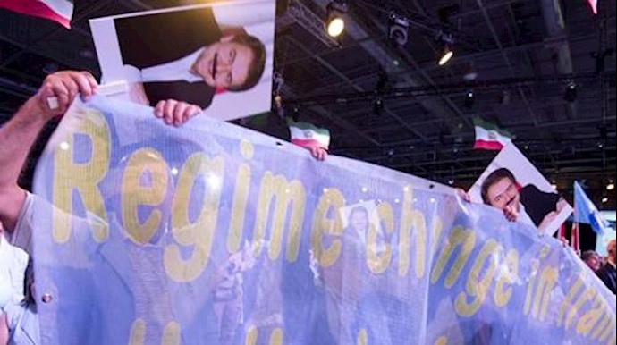  'People hold a banner reading Regime change in Iran during the National Council of Resistance of Iran (CNRI) annual meeting '