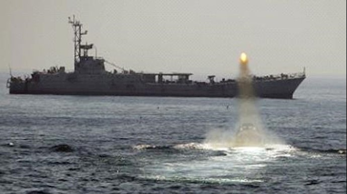  'U.S. Navy aircraft carrier fired a warning shot in an unprofessional confrontation with Iranian vessels'