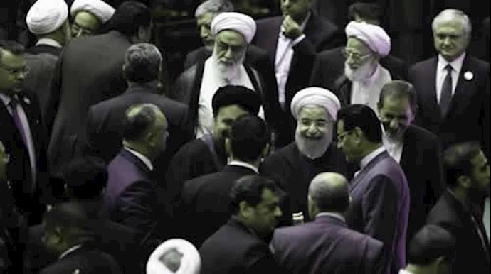  'Iran Hasan Rouhani, center, leaves the parliament at the end of his swearing'